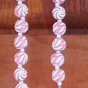 long strand pink and white swirl beads